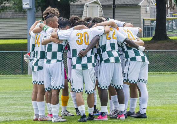 MCCC Men's Soccer Team in a huddle